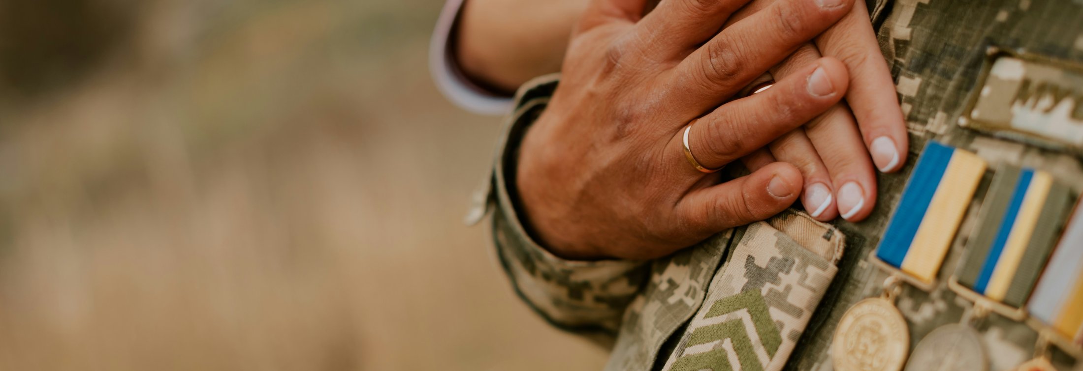 Two hands on military uniform