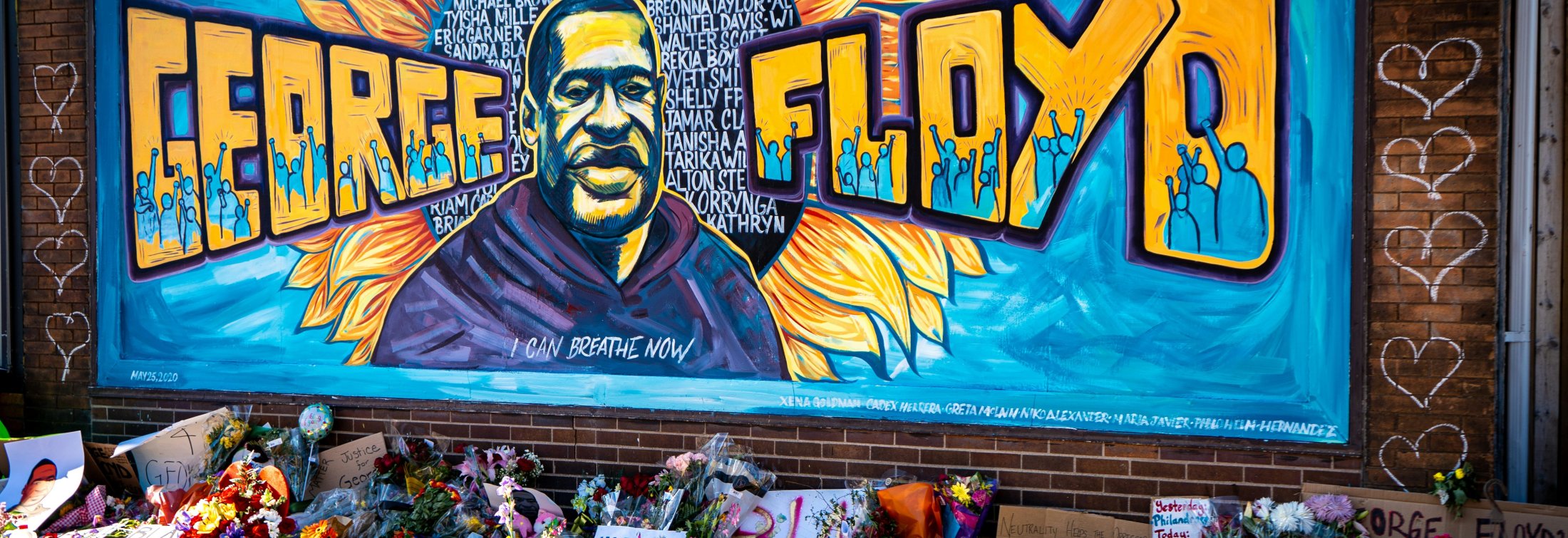 Blue yellow and black graffiti on wall, mural honoring George Floyd from Black Lives Matter protest. 